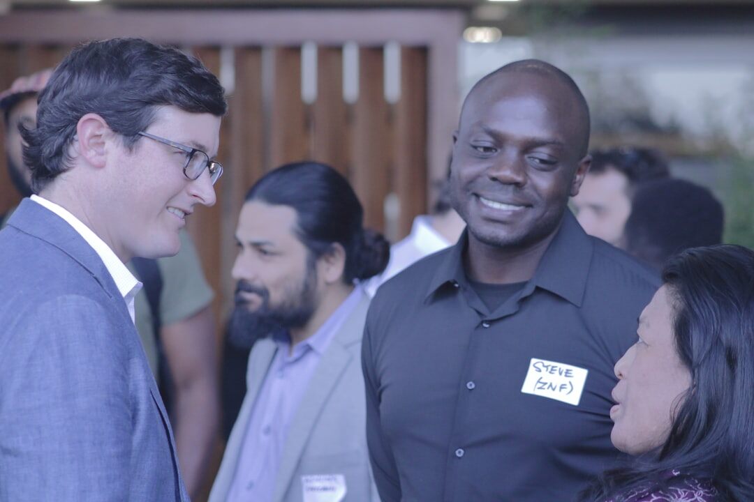 Business professionals networking at an evening corporate conference event